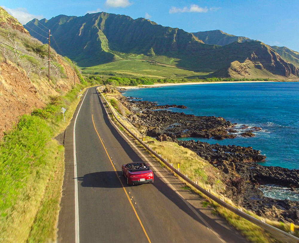Car driving on a Hawaii coastline